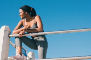 Woman relaxes outdoors whilst on a wellness retreat